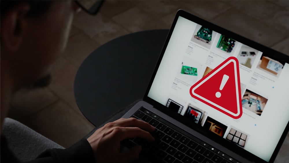 Red triangle and explanation point emergency symbol appears on a laptop display screen.